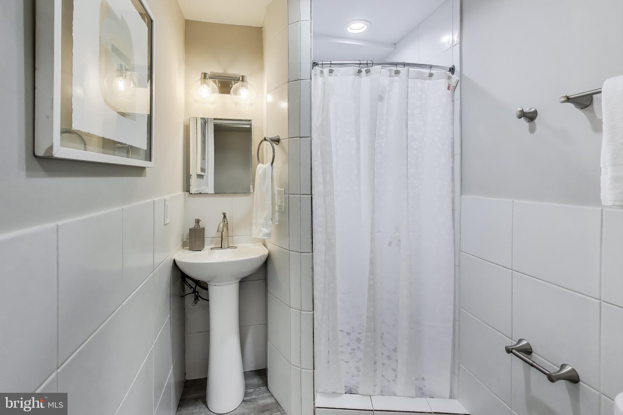 1415 G Street Southeast Washington, DC 20003 - Photo 31 of 42 a bathroom with a sink a toilet and shower