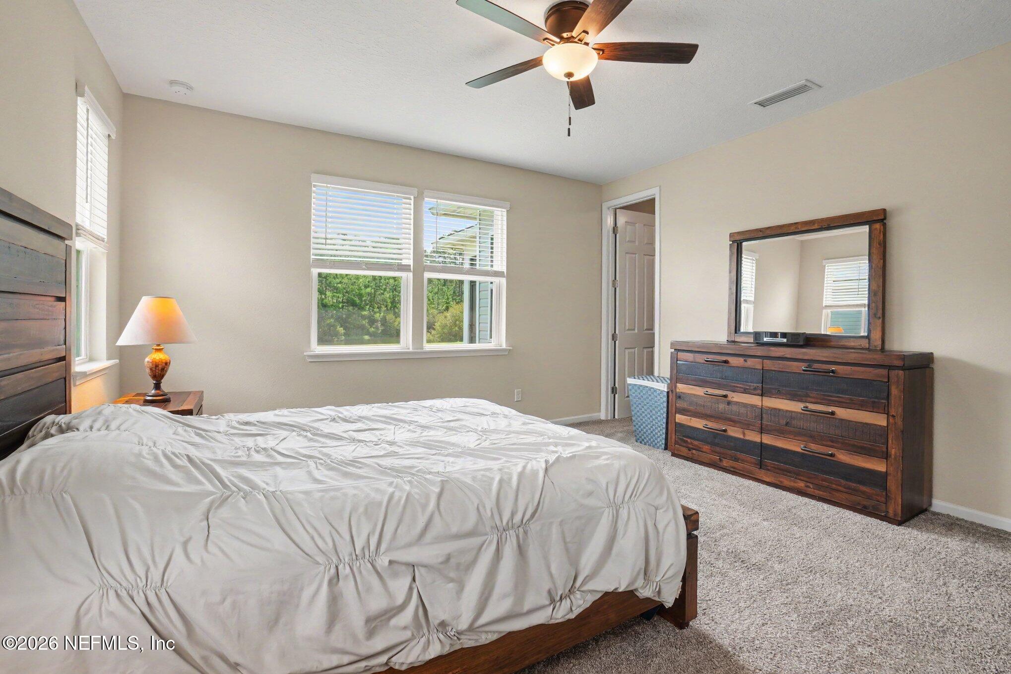 4630 Pine Ridge Parkway Middleburg, FL 32068 - Photo 14 of 35 a bedroom with a bed and wooden floor