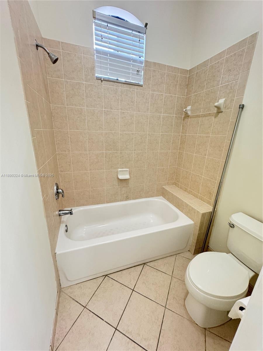 11291 Southwest 240 Lane Homestead, FL 33032 - Photo 16 of 22 a bathroom with a toilet and a bath tub