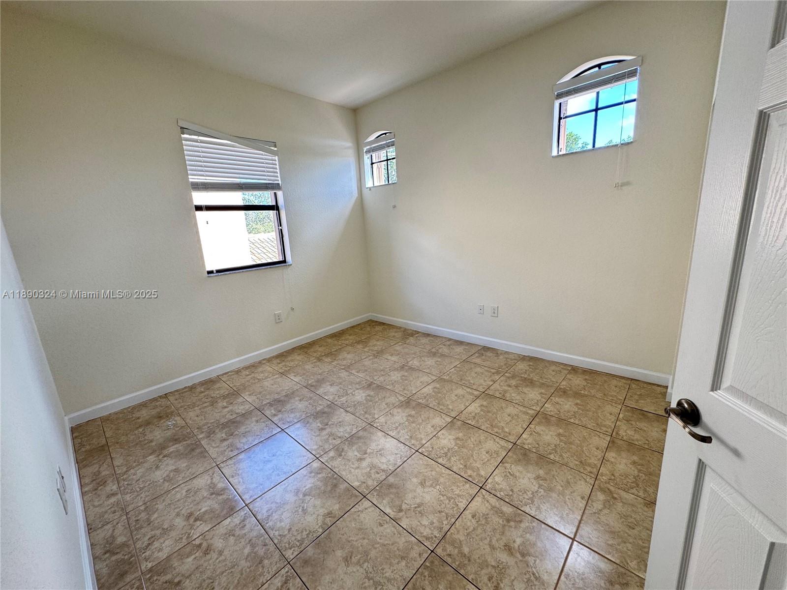 11291 Southwest 240 Lane Homestead, FL 33032 - Photo 17 of 22 a view of an empty room and window