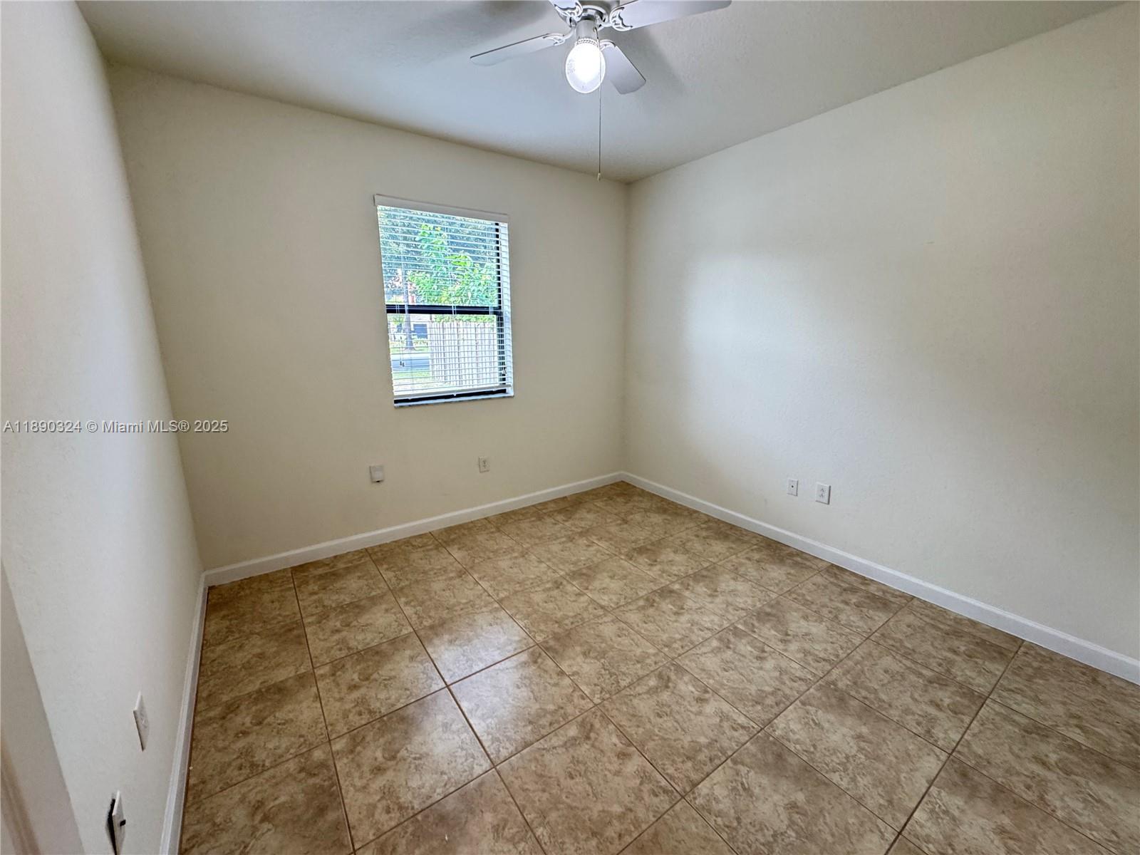 11291 Southwest 240 Lane Homestead, FL 33032 - Photo 6 of 22 an empty room with a window