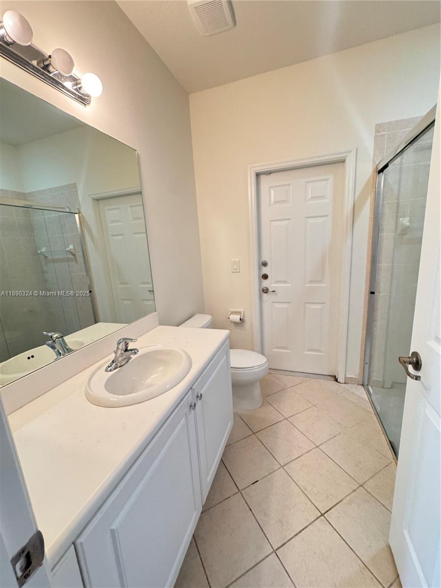 11291 Southwest 240 Lane Homestead, FL 33032 - Photo 7 of 22 a bathroom with a sink a toilet and shower