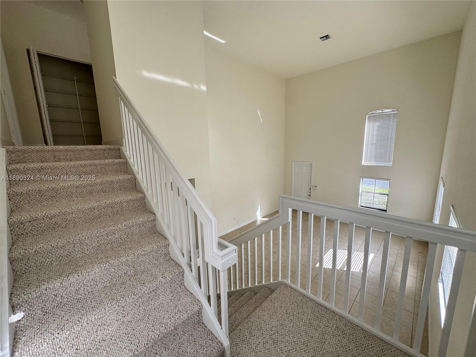 11291 Southwest 240 Lane Homestead, FL 33032 - Photo 9 of 22 a view of staircase with white walls and a window