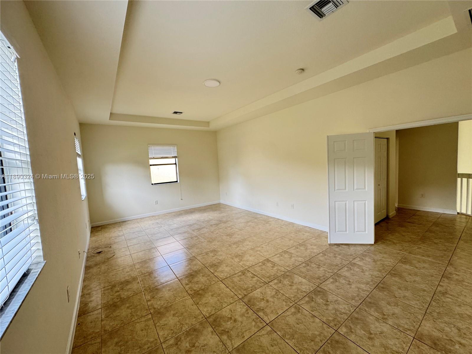 11291 Southwest 240 Lane Homestead, FL 33032 - Photo 10 of 22 an empty room with windows