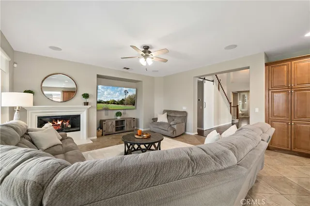 a kitchen with stainless steel appliances granite countertop a refrigerator a sink dishwasher and a stove with wooden floor