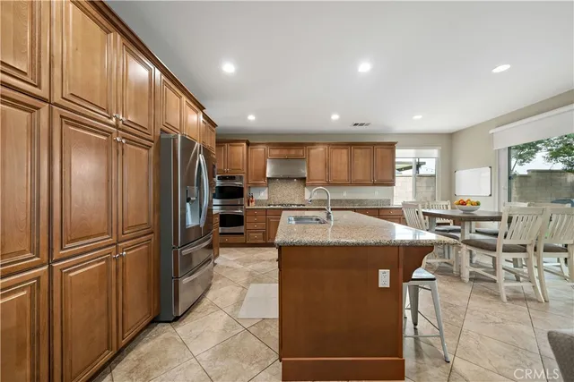 a kitchen with counter top space and living room