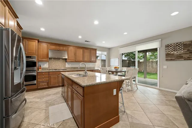 a kitchen with a sink stove and refrigerator
