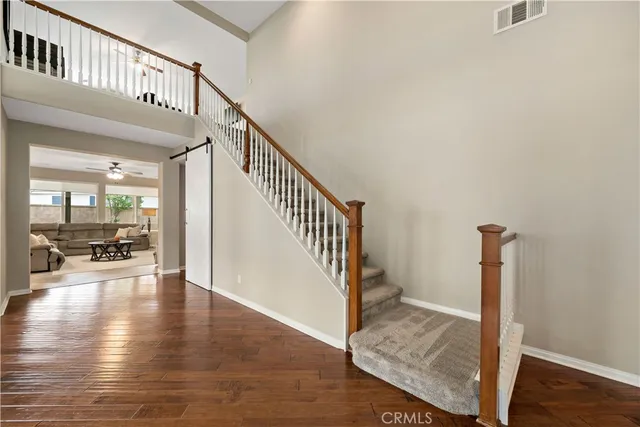 a swimming pool with outdoor seating and covered with trees in the background