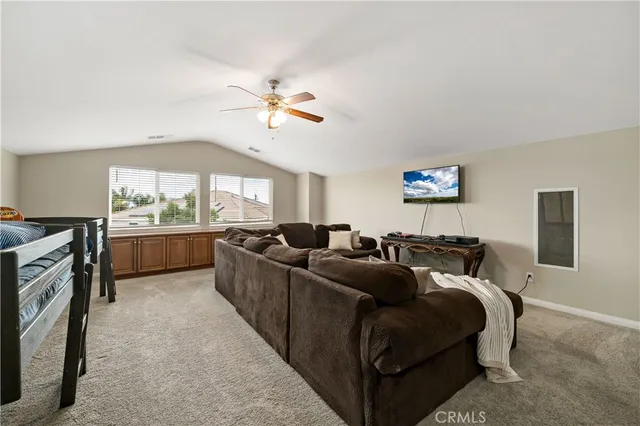 a kitchen with a stove and a view of living room
