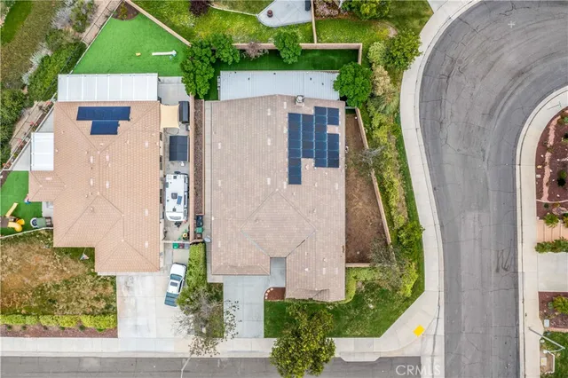 a view of a swimming pool with a lawn chairs under an umbrella