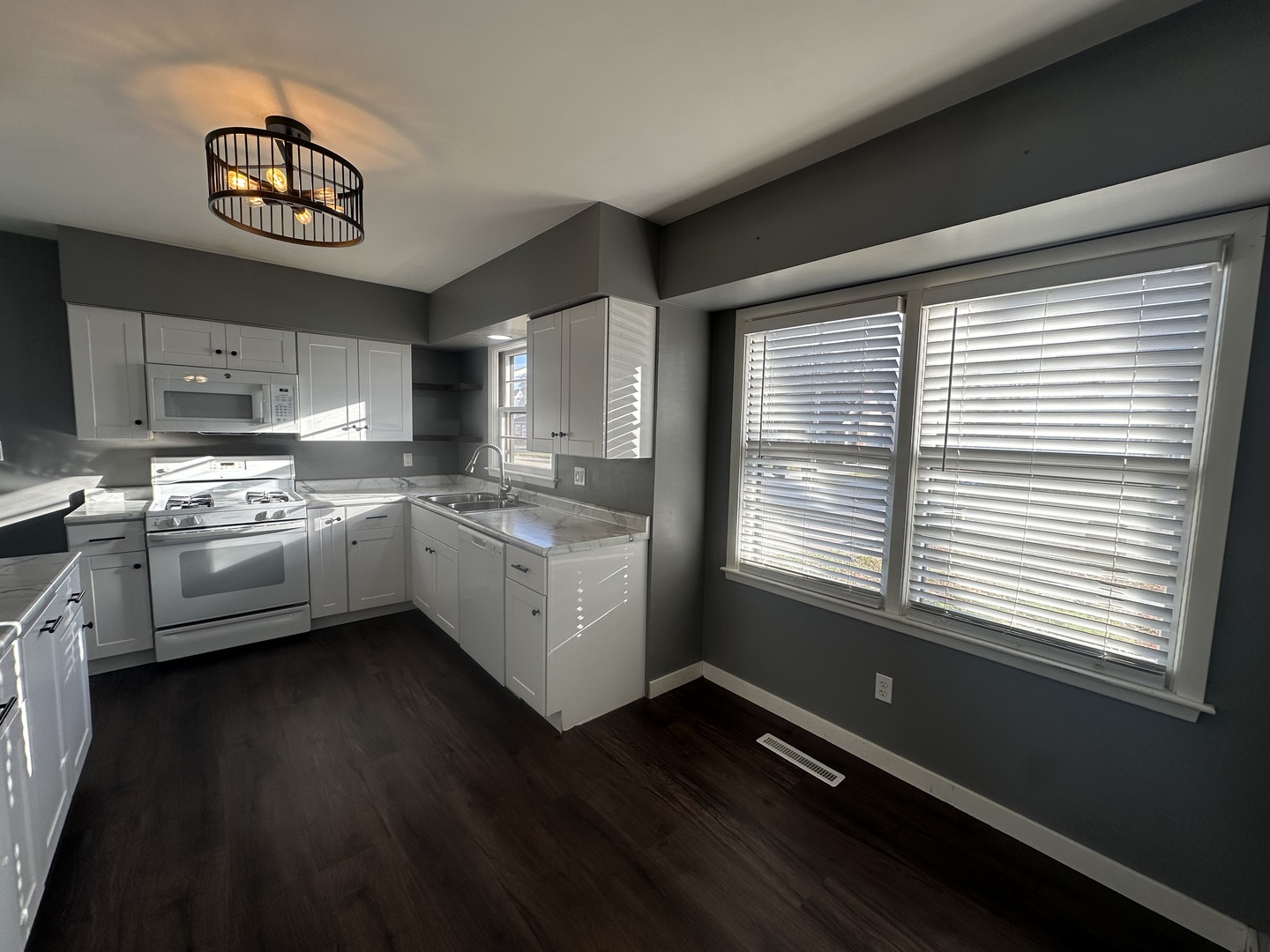 412 East Main Street Morrison, IL 61270 - Photo 11 of 23 a kitchen with stainless steel appliances a sink cabinets and a large window
