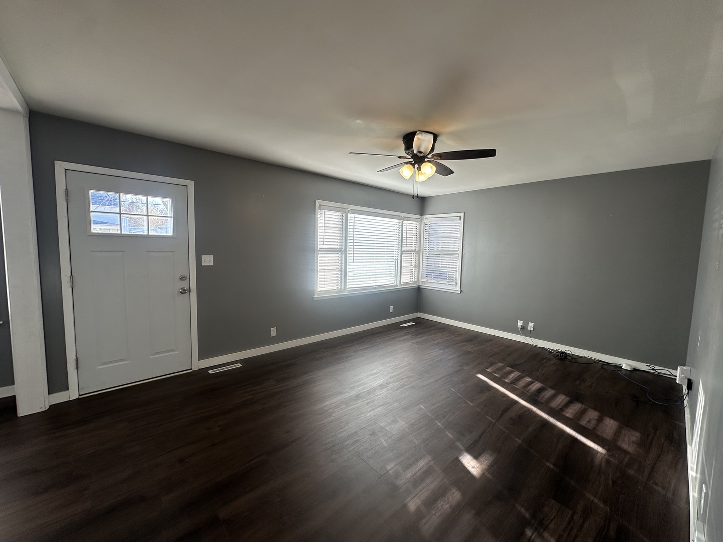 412 East Main Street Morrison, IL 61270 - Photo 9 of 23 an empty room with wooden floor and windows