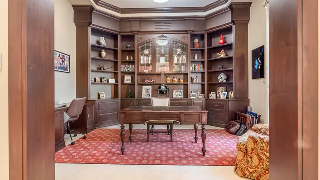 a view of a workspace with furniture and a book shelf