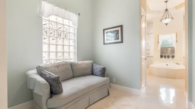 a spacious bathroom with a granite countertop double vanity sink a mirror a bathtub and shower