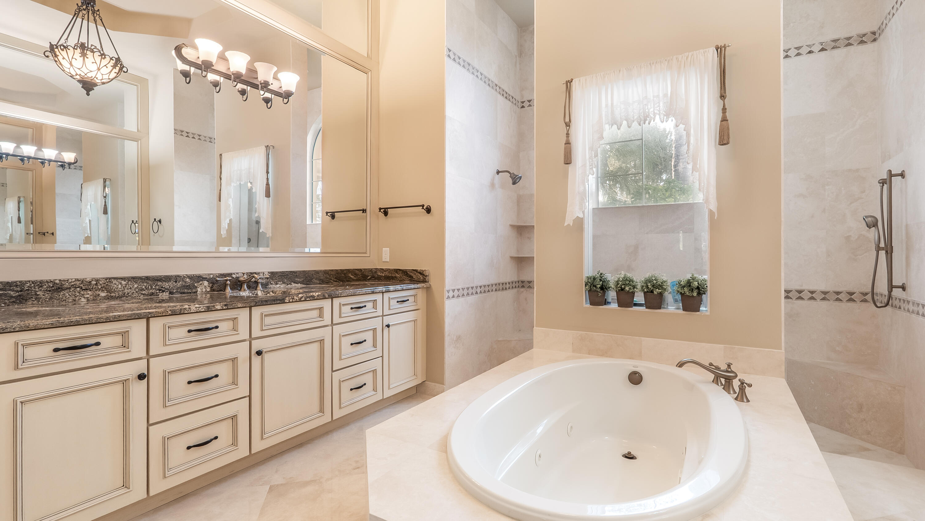 17384 Vistancia Circle Boca Raton, FL 33496 - Photo 21 of 52 a bathroom with a granite countertop sink and a bathtub