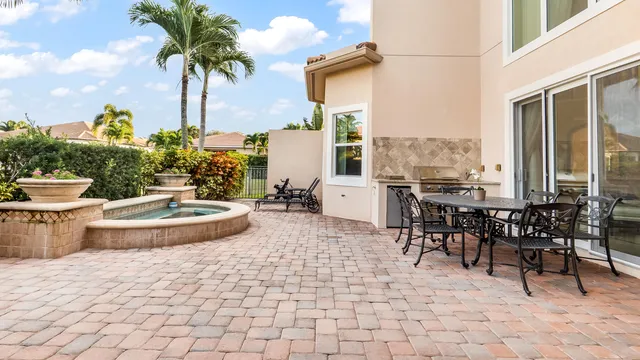a view of a dinning table and chairs in patio of the house