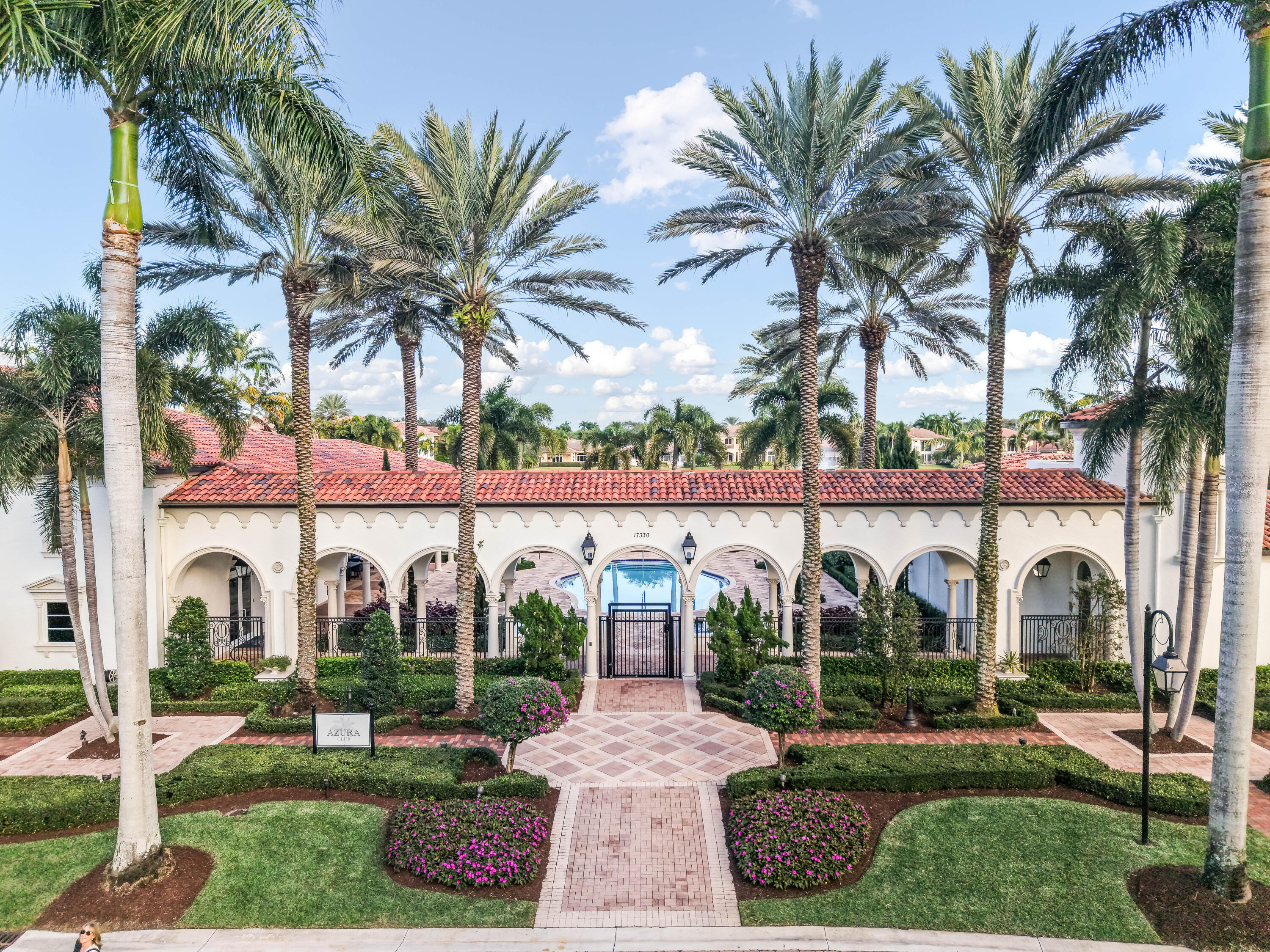 17384 Vistancia Circle Boca Raton, FL 33496 - Photo 49 of 52 a view of palm trees and a yard in front of a house