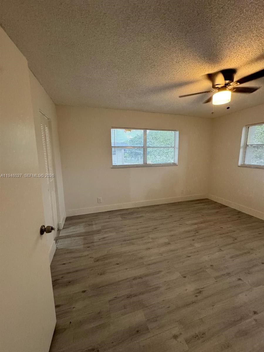 8051 South Colony Circle, Unit 210 Tamarac, FL 33321 - Photo 12 of 25 a view of an empty room with windows