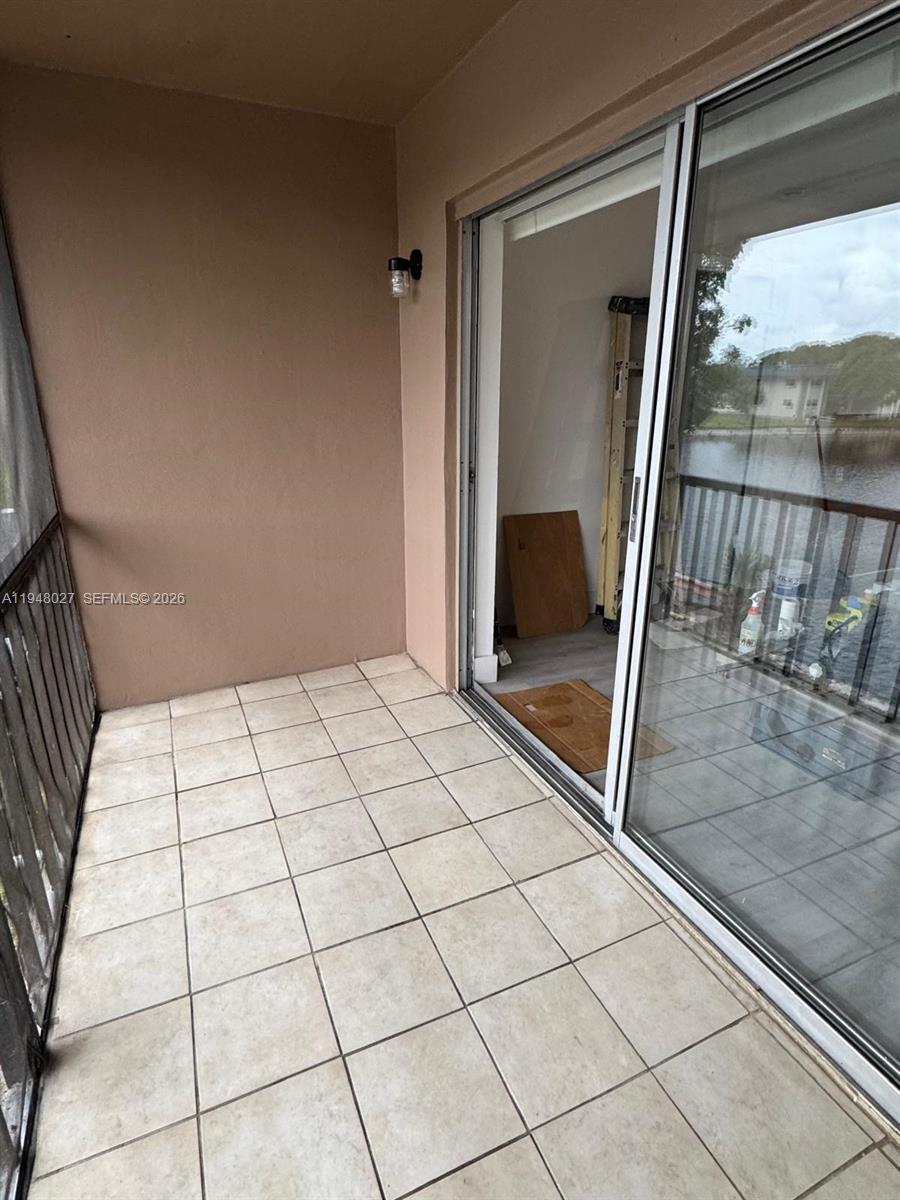 8051 South Colony Circle, Unit 210 Tamarac, FL 33321 - Photo 21 of 25 a view of an empty room and a glass door