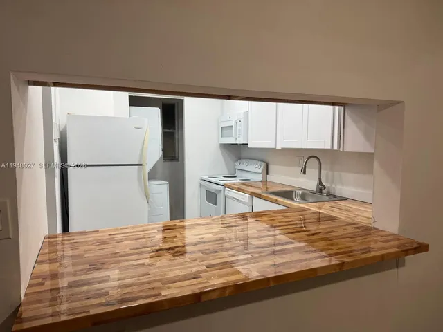 a view of a kitchen with a sink