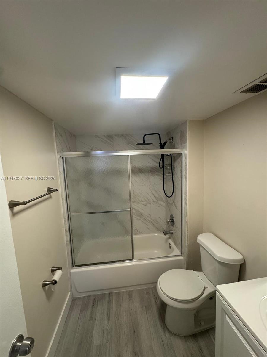 8051 South Colony Circle, Unit 210 Tamarac, FL 33321 - Photo 10 of 25 a bathroom with a toilet and a shower