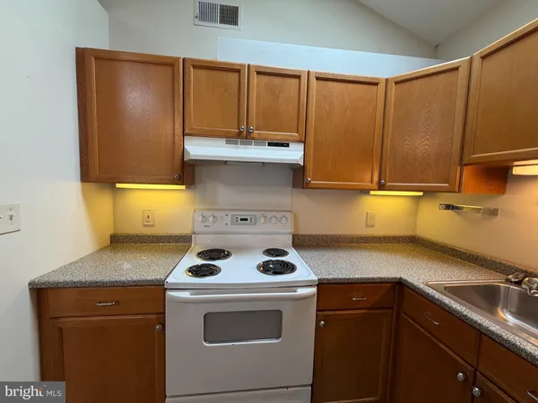 a kitchen with a stove and a cabinets
