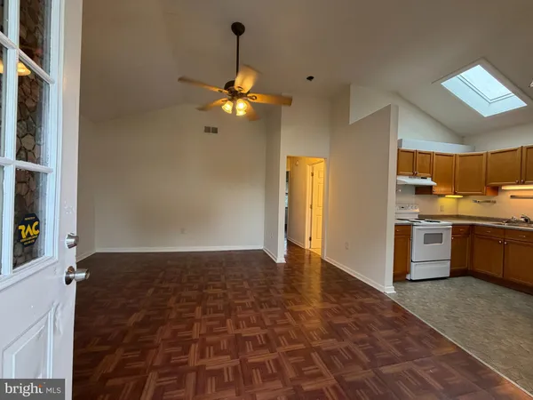 a view of a room with a ceiling fan and a window