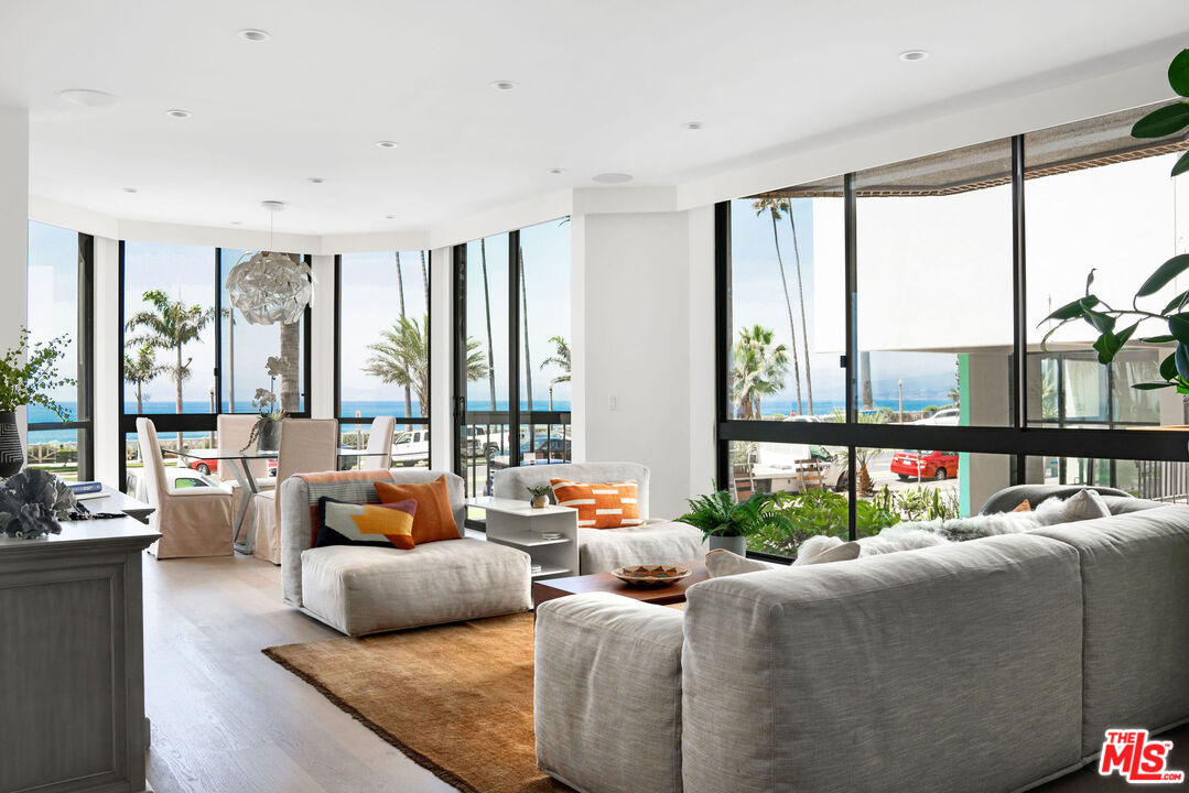 1033 Ocean Avenue, Unit 104 Santa Monica, CA 90403 - Photo 1 of 26 a bedroom with furniture and large windows