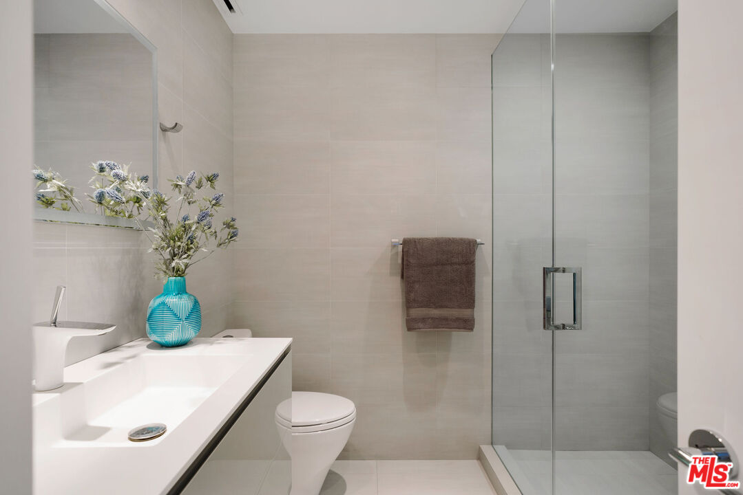 1033 Ocean Avenue, Unit 104 Santa Monica, CA 90403 - Photo 11 of 26 a bathroom with a sink a toilet and shower