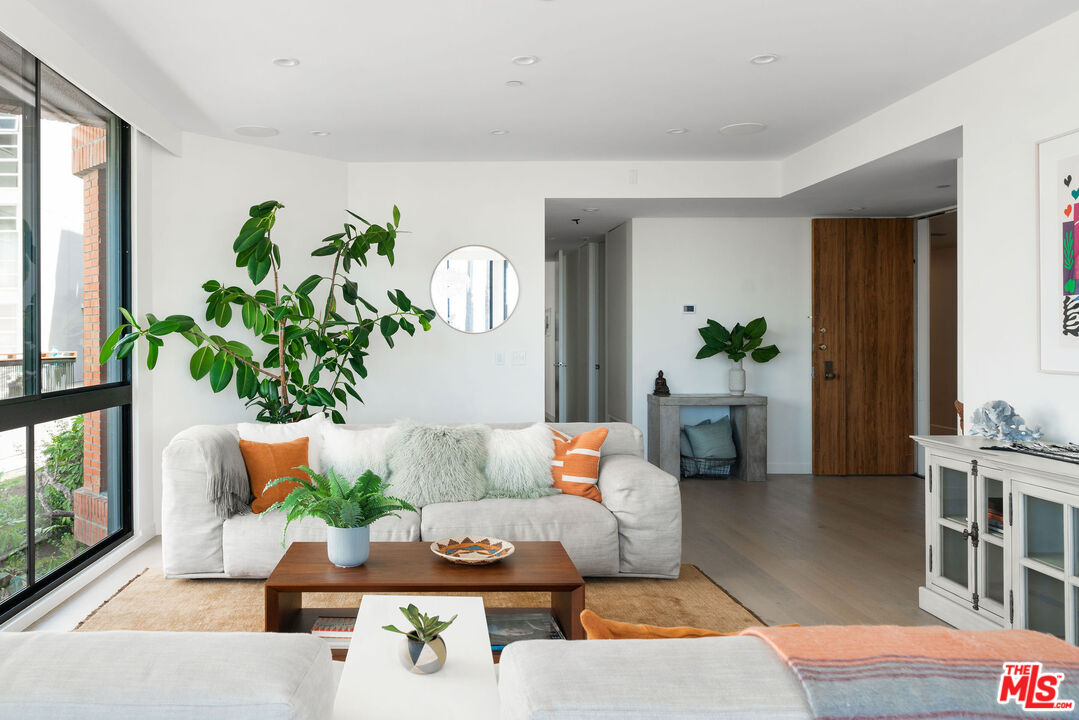 1033 Ocean Avenue, Unit 104 Santa Monica, CA 90403 - Photo 3 of 26 a living room with furniture and a potted plant