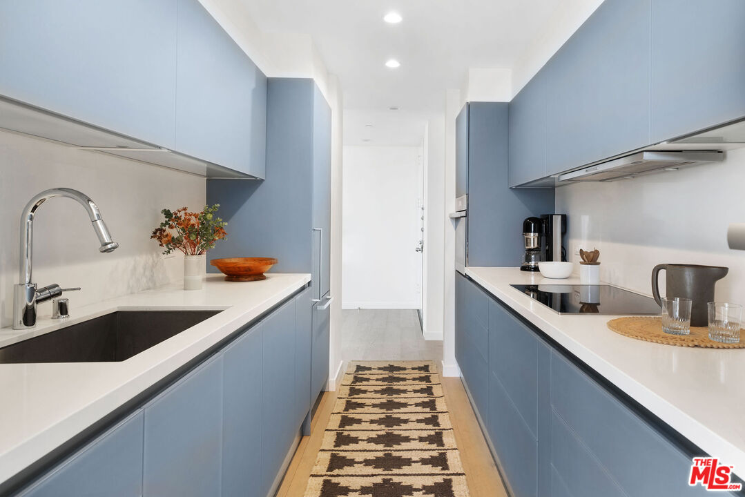 1033 Ocean Avenue, Unit 104 Santa Monica, CA 90403 - Photo 7 of 26 a kitchen with sink and cabinets