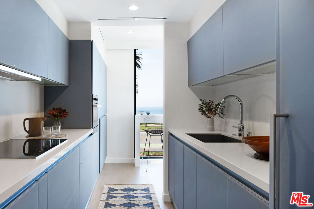 1033 Ocean Avenue, Unit 104 Santa Monica, CA 90403 - Photo 8 of 26 a kitchen with a sink and refrigerator