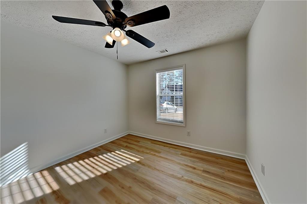 3616 Hollyhock Way Northwest Kennesaw, GA 30152 - Photo 11 of 18 wooden floor in an empty room with a window