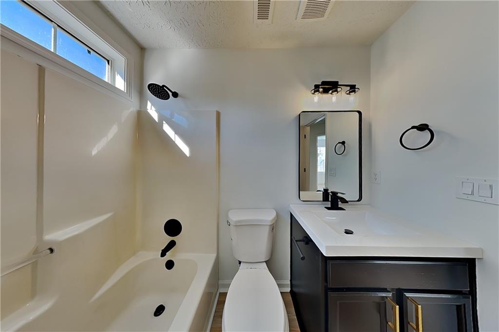 3616 Hollyhock Way Northwest Kennesaw, GA 30152 - Photo 14 of 18 a bathroom with a sink a toilet and shower