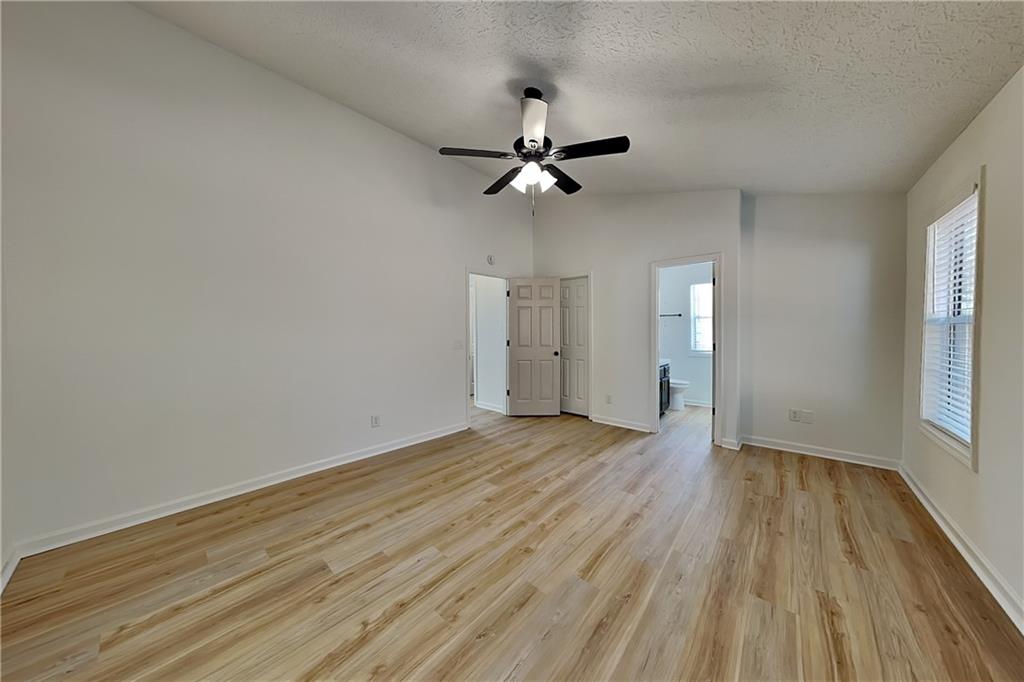 3616 Hollyhock Way Northwest Kennesaw, GA 30152 - Photo 6 of 18 an empty room with wooden floor ceiling fan and window