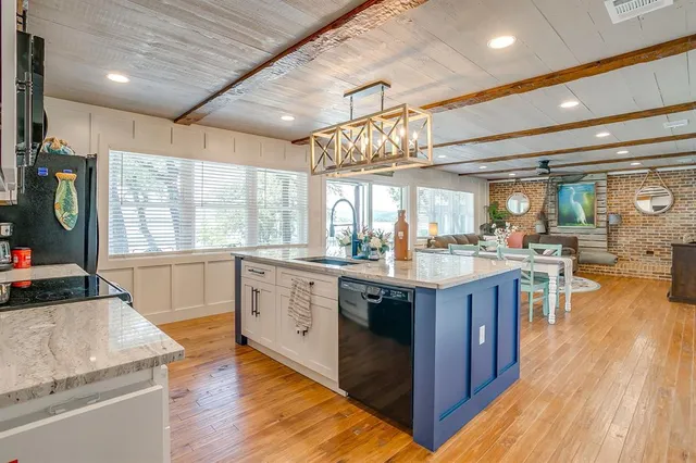 an aerial view of residential houses with outdoor space and trees