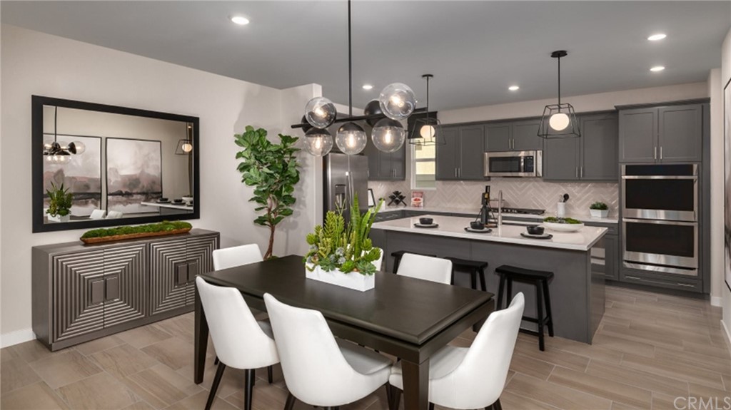 41114 Harvey Mudd Drive Palm Desert, CA 92211 - Photo 2 of 10 a kitchen with kitchen island a dining table and chairs