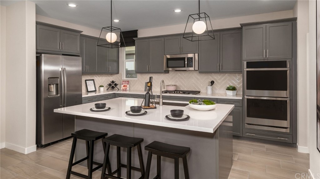 41114 Harvey Mudd Drive Palm Desert, CA 92211 - Photo 4 of 10 a kitchen with refrigerator cabinets and microwave