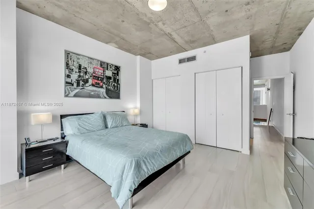 a bedroom with a bed and a walk in closet