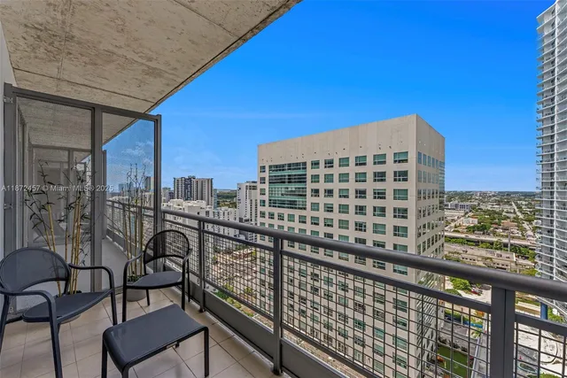 a view of a balcony with a couple of chairs