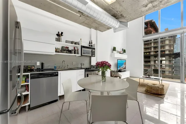 a kitchen with a sink appliances and cabinets