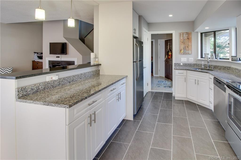 134 Watch Hill Road, Unit 134 Branford, CT 06405 - Photo 1 of 1 a kitchen with stainless steel appliances granite countertop a sink and a stove