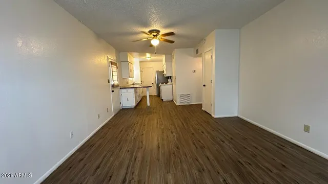 a view of a room with wooden floor and staircase