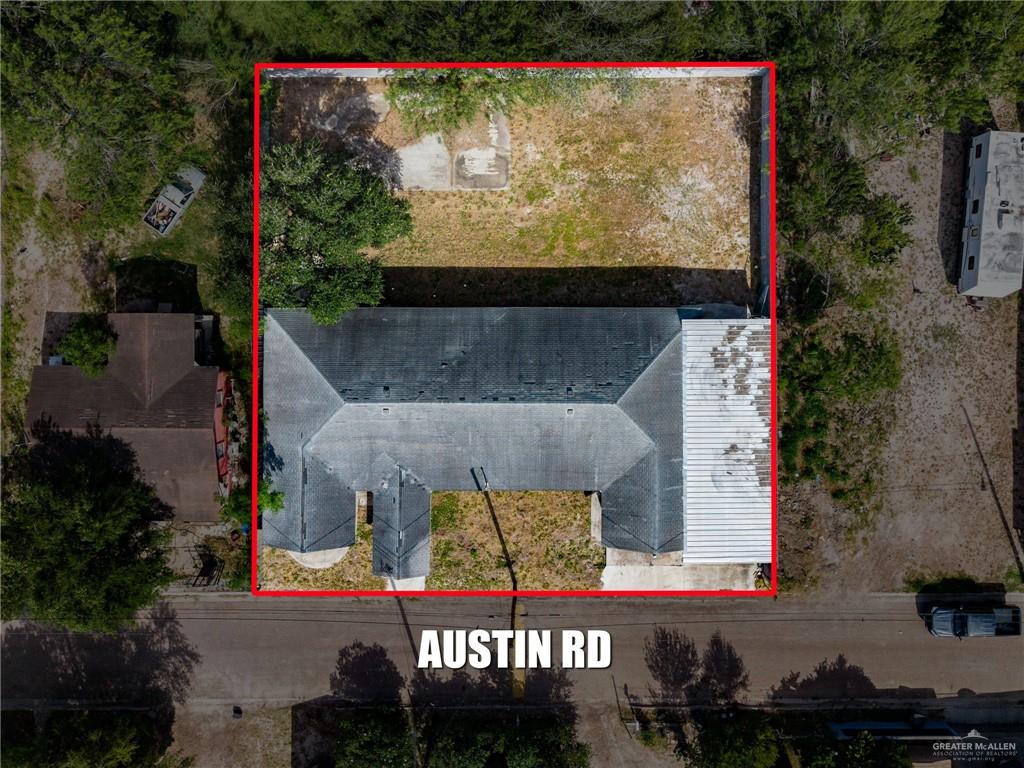 879 Austin Road Roma, TX 78584 - Photo 3 of 7 Aerial view showcasing a property parcel with a structure featuring a multi-pitched roofline, a separate flat-roofed section, and a cleared land area