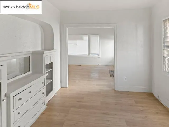 view of an empty room with window and cabinet