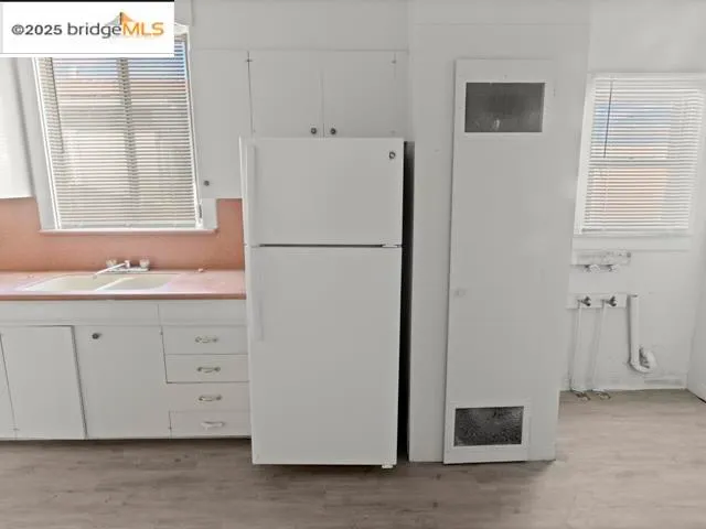 a white refrigerator freezer sitting in a kitchen