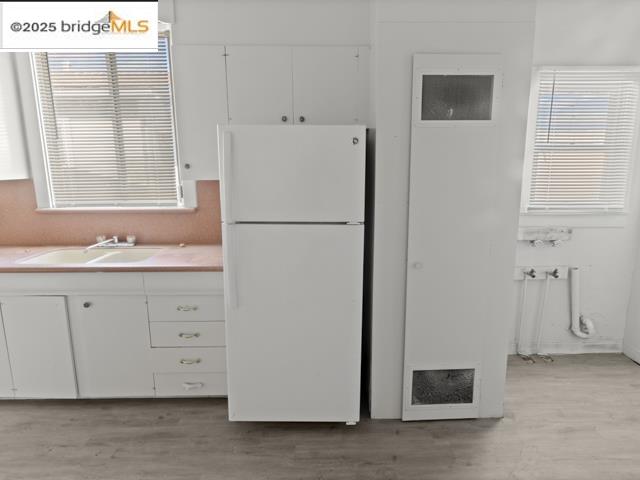 1556 78th Avenue Oakland, CA 94621 - Photo 6 of 11 a white refrigerator freezer sitting in a kitchen