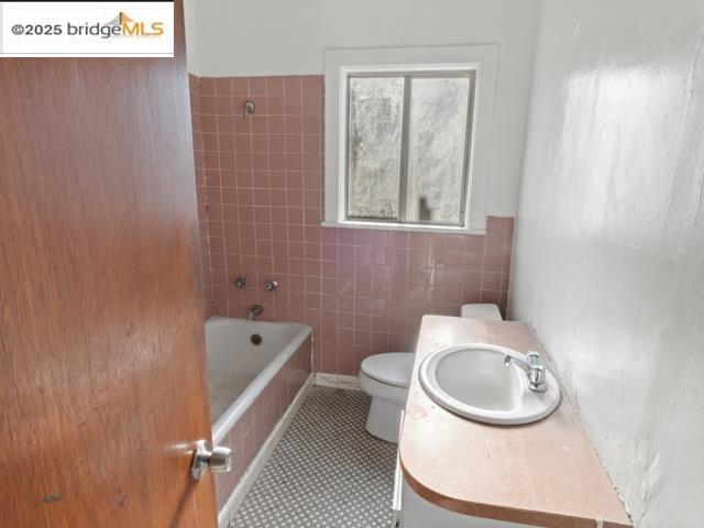 1556 78th Avenue Oakland, CA 94621 - Photo 9 of 11 a bathroom with a toilet and a sink