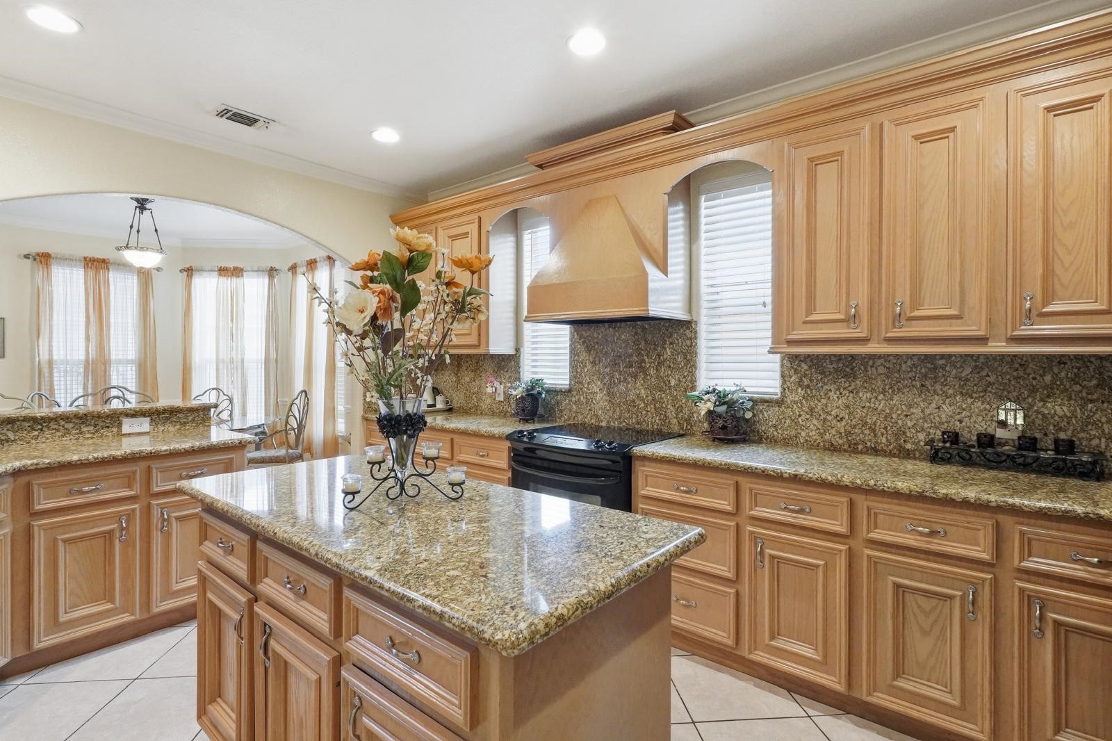 247 Old Spring Lane Houston, TX 77015 - Photo 5 of 25 a kitchen with kitchen island granite countertop a sink cabinets and window