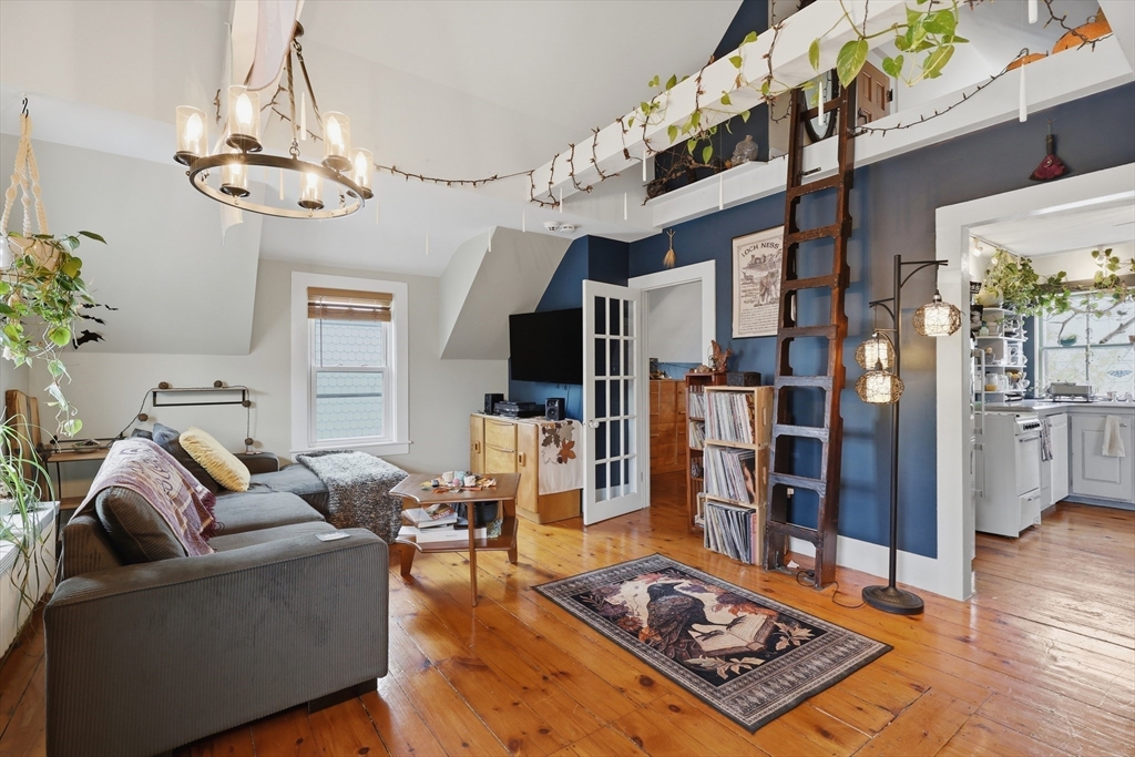 a living room with furniture and a chandelier